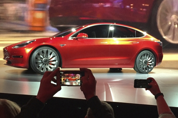 In this file photo, Tesla Motors unveils the new lower-priced Model 3 sedan at the Tesla Motors design studio in Hawthorne, Calif. Electric car maker Tesla said on Monday that its Model 3 car will go on sale on Friday. — AP
