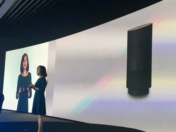 A member of staff from Alibaba Group introduces the company's newly released cut-price voice assistant speaker Tmall Genie during a press conference in Beijing, China, on Wednesday. — Reuters