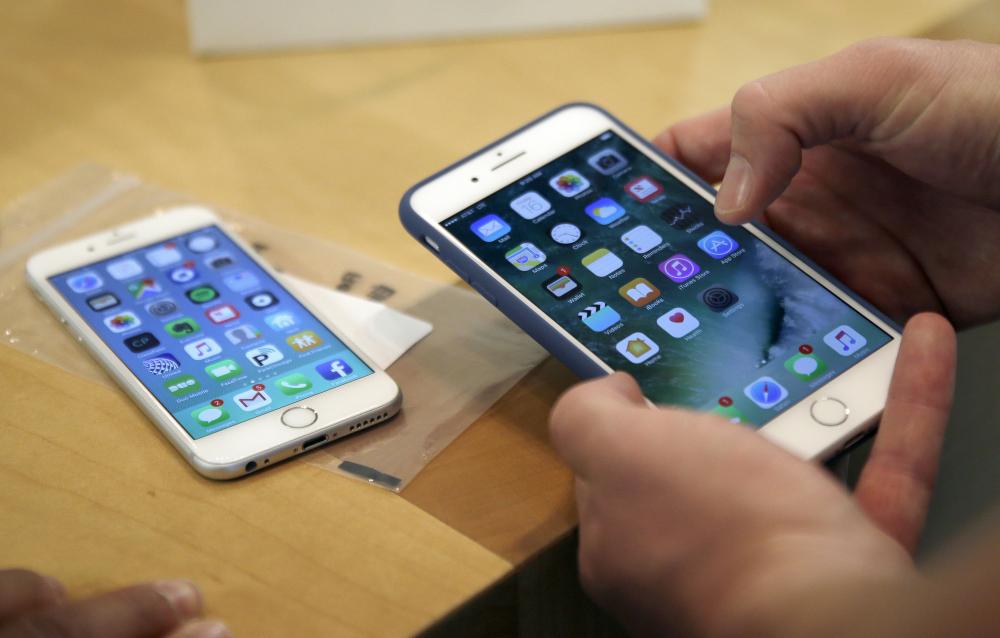 In this file photo, a customer sets up his new iPhone 7 Plus, right, as he switches from the iPhone 6 at the Apple Store on Michigan Avenue during the release of the Apple iPhone 7 and the latest Apple Watches, in Chicago. Qualcomm is seeking to block iPhone shipments to the US, arguing that the phones infringe on six of its patents. — AP