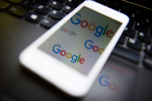 This file photo tshows the logo of US technology company and search engine Google displayed on screens. — AFP
