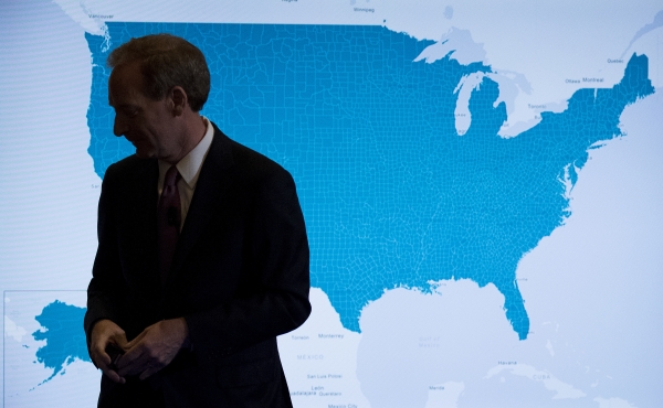 Microsoft President and Chief Legal Officer Brad Smith pauses in front of a monitor displaying the US as he speaks in Washington, Tuesday about Microsoft's project to bring broadband Internet access to rural parts of the United States. — AP