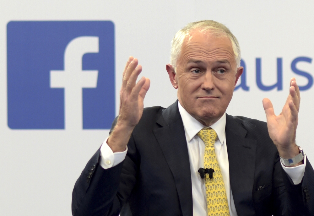 In this file photo, Australian Prime Minister Malcolm Turnbull raises his hands as he speaks during a leaders debate hosted by Facebook Australia and News.com.au in Sydney. The Australian government on Friday proposed a new cybersecurity law to force global technology companies such as Facebook and Google to help police by unscrambling encrypted messages sent by suspected extremists and other criminals. — AP