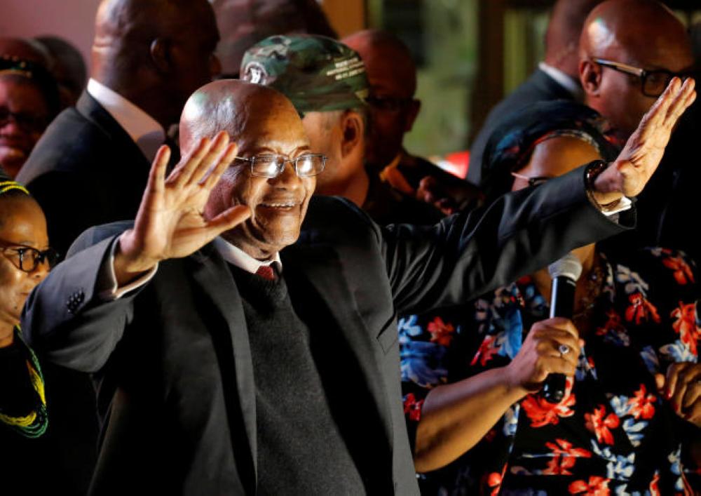South Africa's President Jacob Zuma celebrates with his supporters after he survived a no-confidence motion in parliament in Cape Town. — 