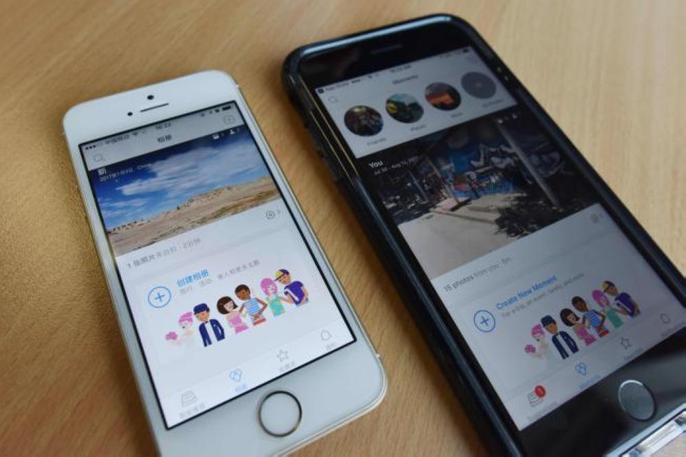 This photo illustration shows Facebook's Colorful Balloons app, left, next to its Moments app, right, at an office in Beijing on Tuesday. — AFP
