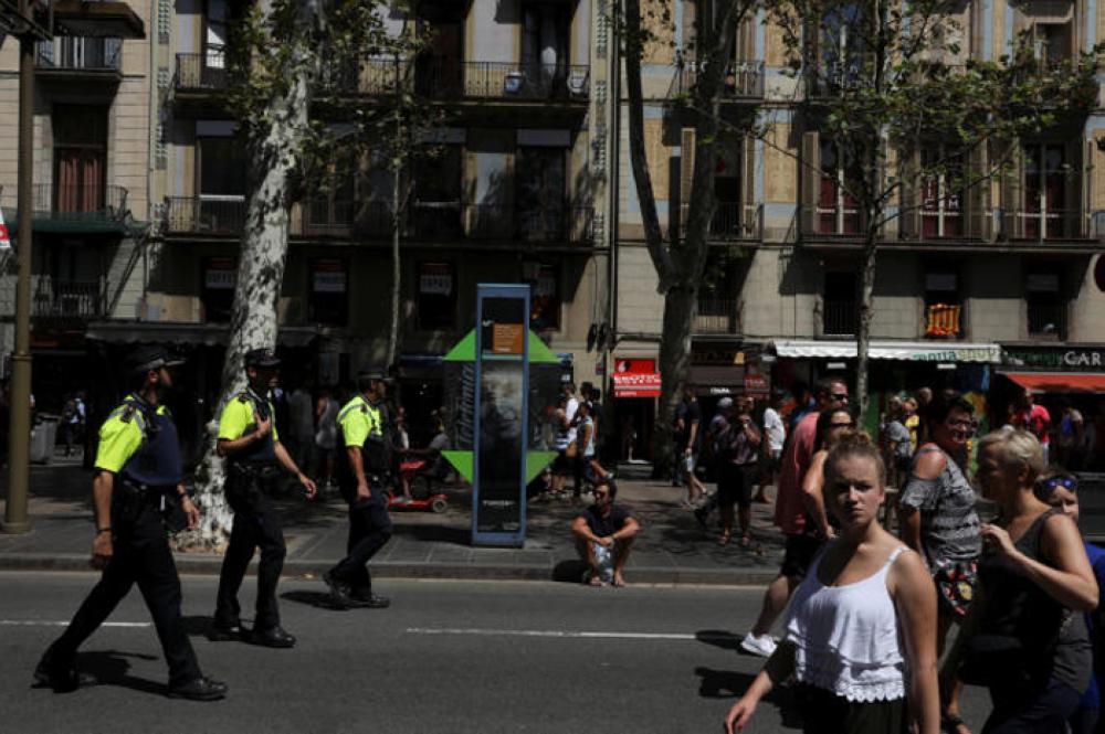 Police officers patrol a day after a van crashed into pedestrians at Las Ramblas in Barcelona