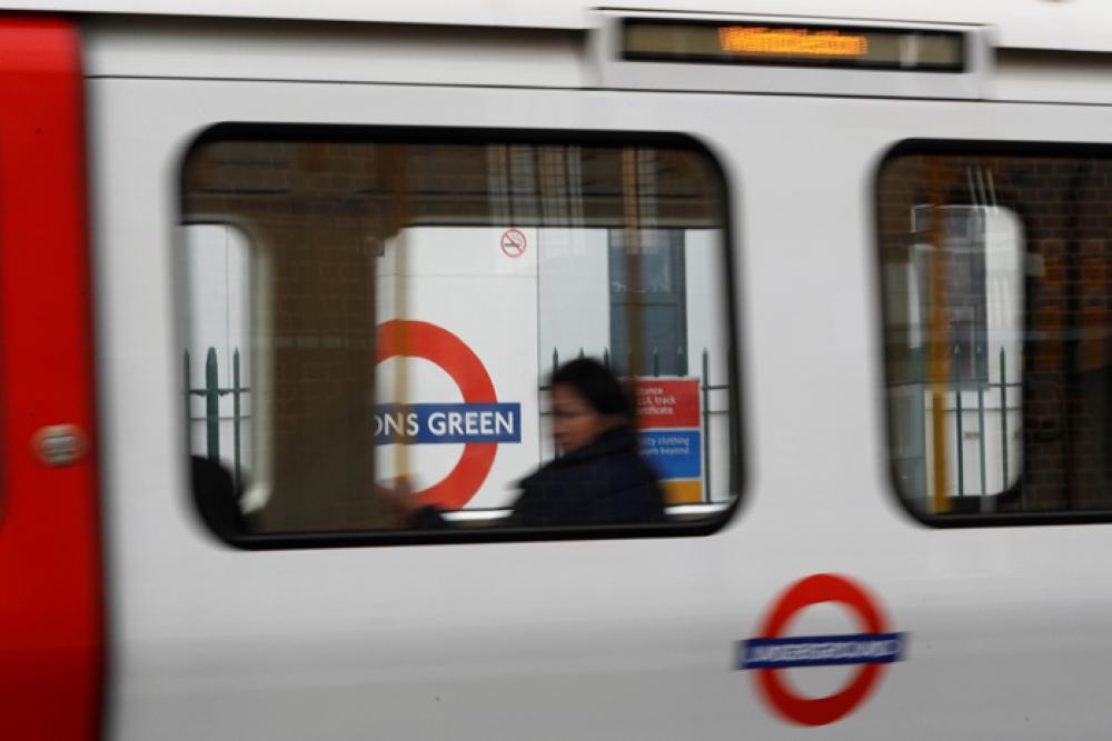 A passenger sits on an underground train leaving Parson's Green station after it reopened following an explosion on a rush hour train Friday morning, in London, Britain. Reuters