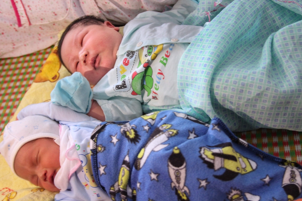 Baby boy Tran Tien Quoc, top, next to an unidentified baby at the Vinh Tuong district medical center in Vinh Phuc province, Vietnam. - AFP