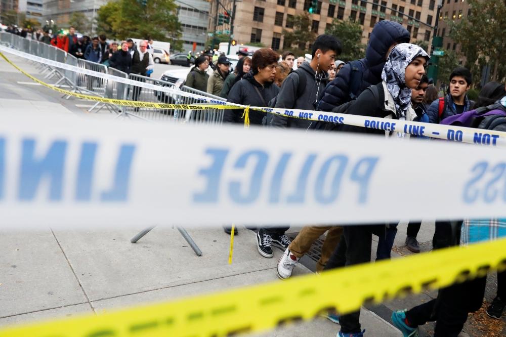 Students walk past police line tape on their way to school a day after a man driving a rented pickup truck mowed down pedestrians and cyclists on a bike path alongside the Hudson River in New York City, in New York, US October 31, 2017. - Reuters