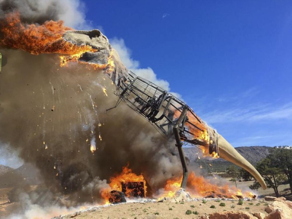 Gone extinct: Animatronic T-Rex bursts into flames at the Royal Gorge Dinosaur Experience in Canon City, Colorado. - AP
