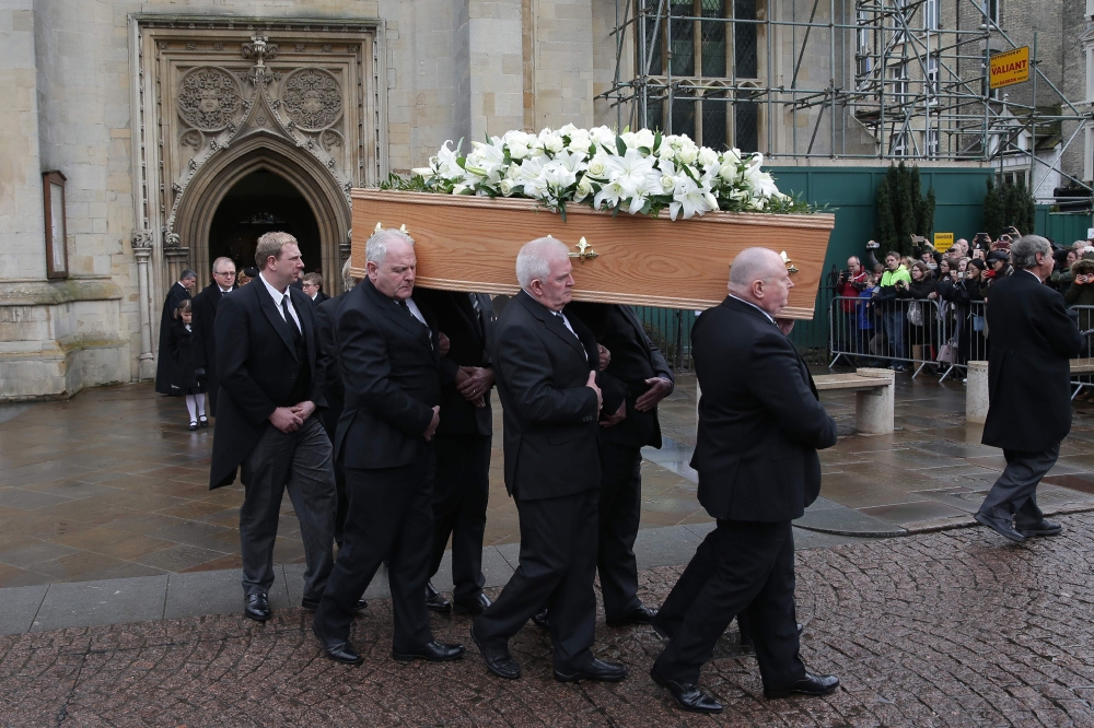 Porters of Gonville & Caius College, act as pallbearers and carry the coffin of British scientist Stephen Hawking after the funeral service at the Church of St Mary the Great, in Cambridge on Sunday. - AFP