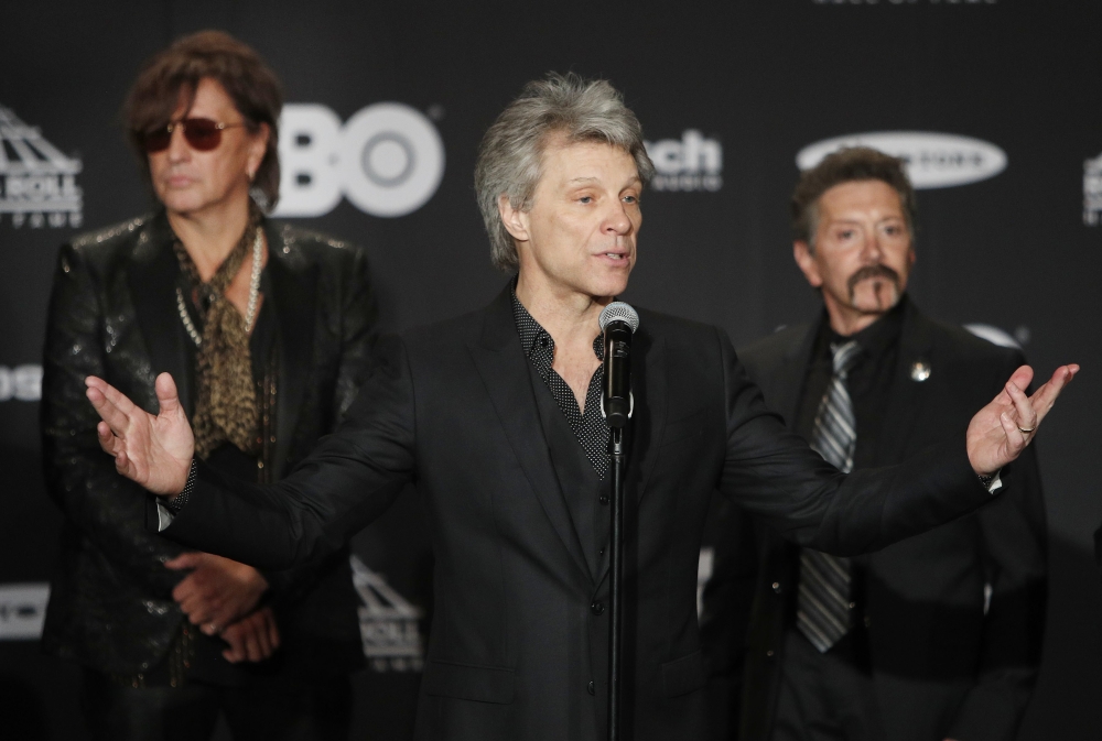 From left, members of the US rock group Bon Jovi - Richie Sambora, Jon Bon Jovi and Alec John Such appear in the media room at the Rock and Roll Hall of Fame induction ceremony at Public Hall in Cleveland, Ohio on Sunday. - EPA