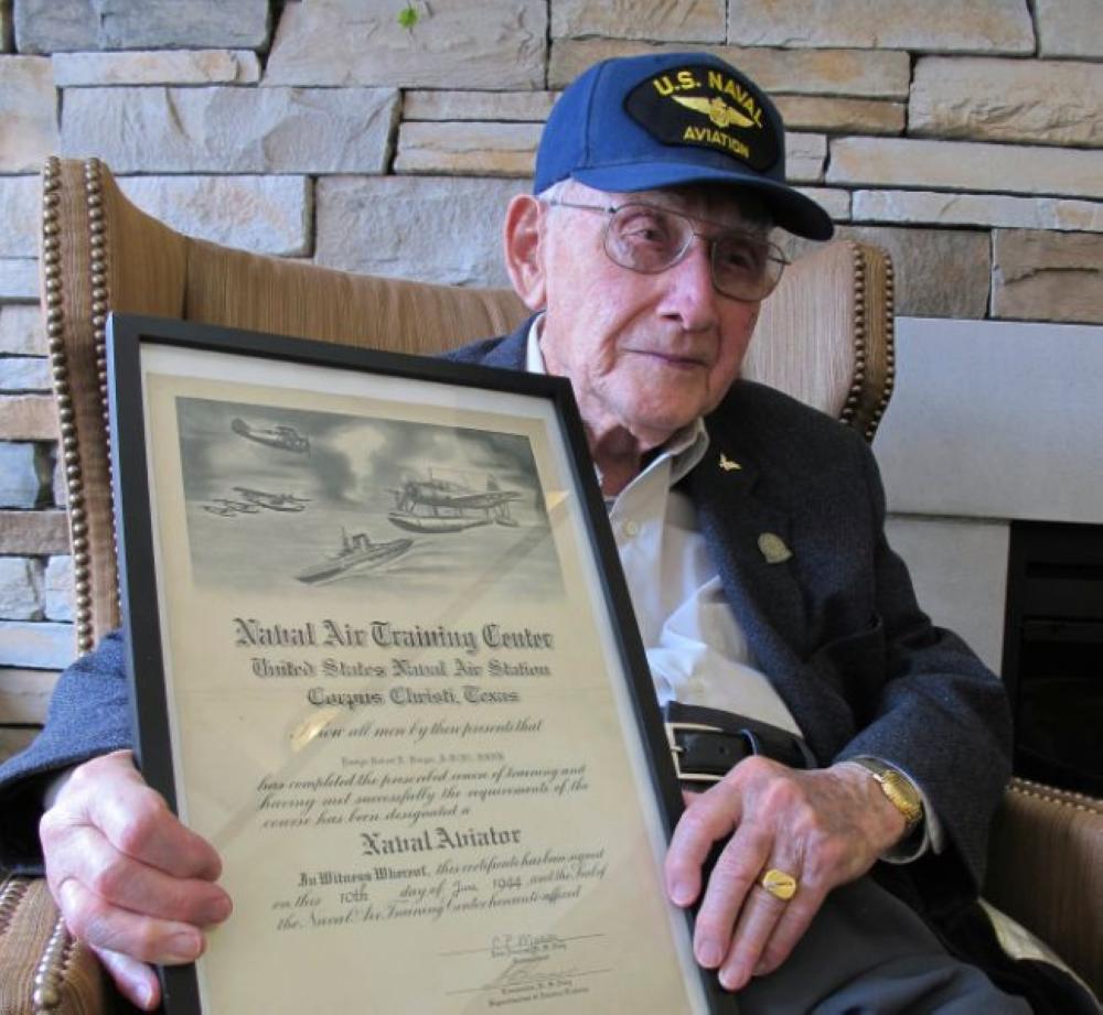 World War II veteran Bob Barger poses with his Naval flight school certificate in Toledo, Ohio. - AP