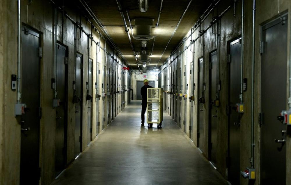A man pushes a cart through the hallway of the nitrate film vaults at the Library of Congress's National Audio-Visual Conservation Center in Culpeper, Virginia. - AFP
