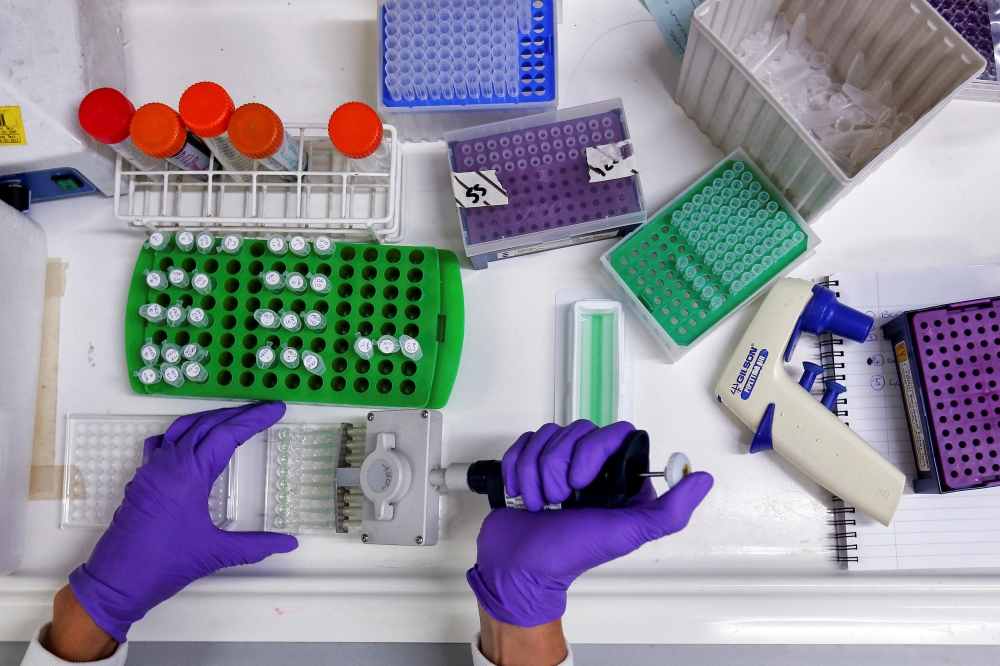 A scientist prepares protein samples for analysis in a lab at the Institute of Cancer Research in Sutton, England - Reuters