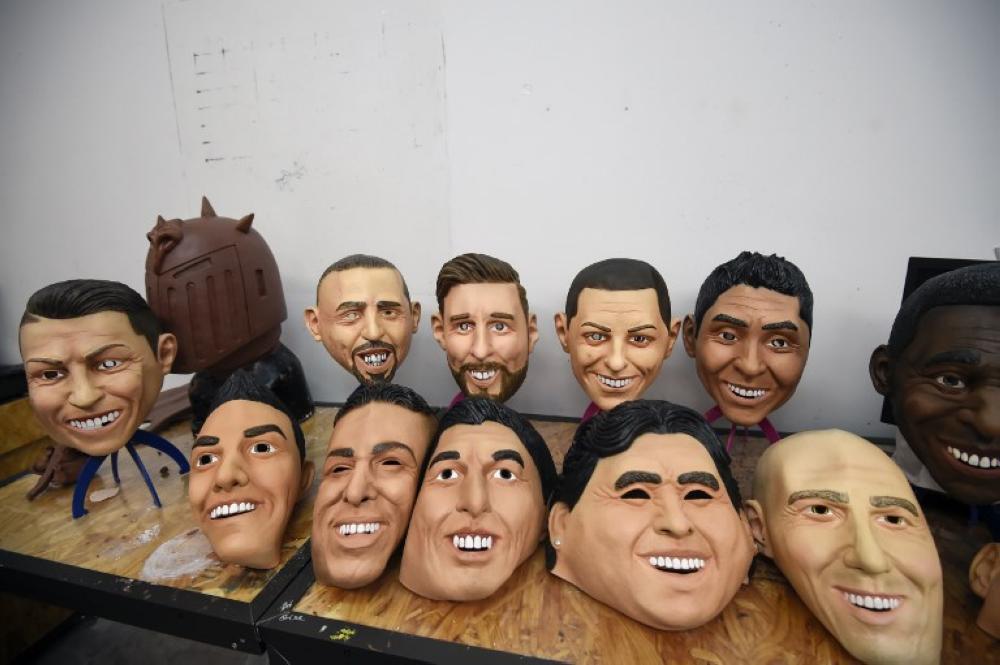 Latex masks of famous football players are displayed at a factory in Jiutepec, Morelos State, Mexico. - AFP