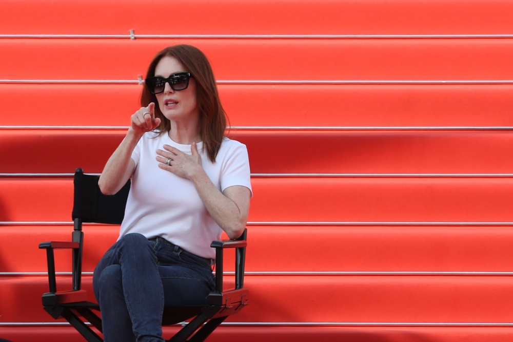 Actress Julianne Moore gestures as she takes part in the shooting of a promotional event on the red carpet outside the festival's palace on Tuesday, ahead of the opening ceremony of the 71st edition of the Cannes Film Festival in Cannes, southern France. - AFP