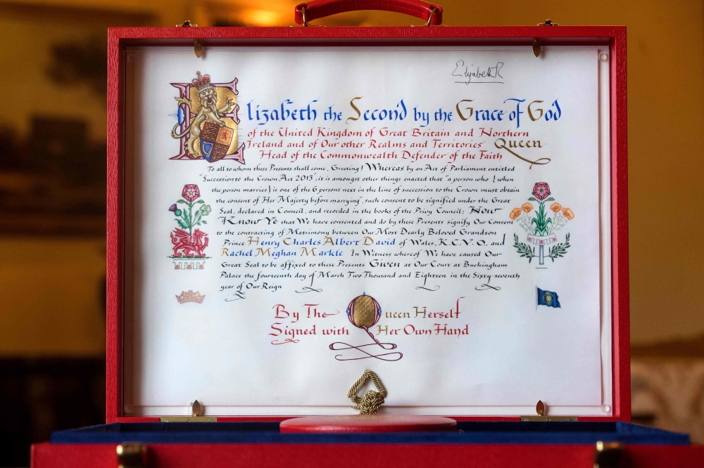 A picture taken at Buckingham Palace in London on Sunday shows the Instrument of Consent, an official State document that records the Queen's formal consent to Prince Harry's forthcoming marriage to Meghan Markle. - AFP