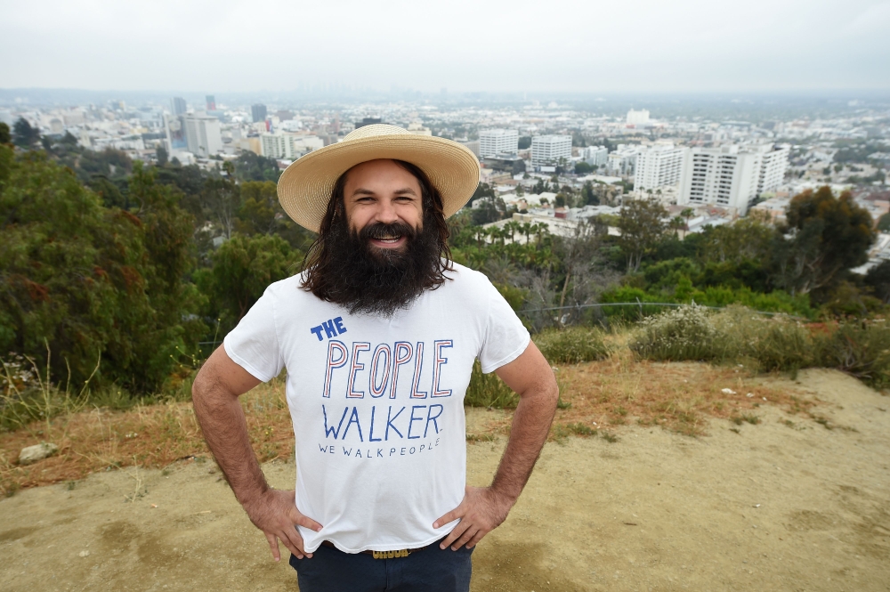Chuck McCarthy discusses his passion for his work as a professional people walker in Runyon Canyon Park in Los Angeles, California on Sunday. - AFP