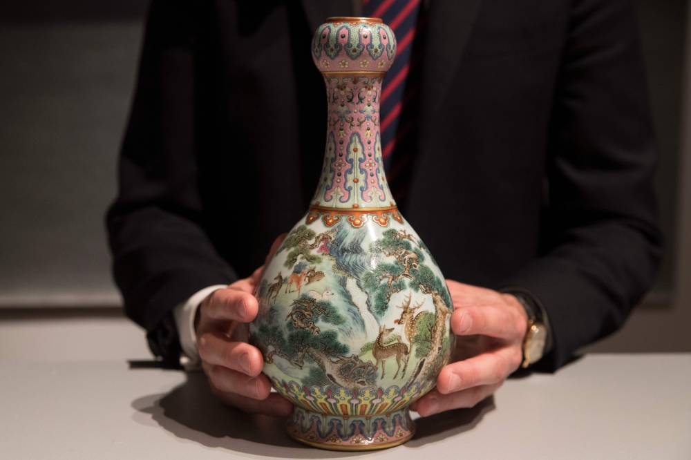 In this file photo taken on May 22, 2018 a rare Imperial Qianlong porcelain vase (18th century) is displayed at Sotheby's auction company in Paris.  An 18th-century Chinese vase forgotten for decades in a shoe box in a French attic has been sold for 16.2 million euros ($19 million) at Sotheby's in Paris on Tuesday — more than 30 times the estimate. — AFP 