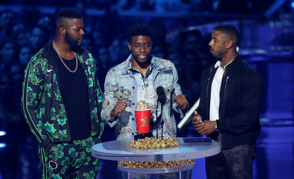 From left, actors Winston Duke, Chadwick Boseman and Michael B. Jordan accept the Best Movie award for 