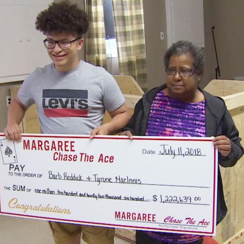 Barbara Reddick and her nephew Tyrone MacInnis pose with their winning lottery ticket in Margaree Forks, Canada on Friday.