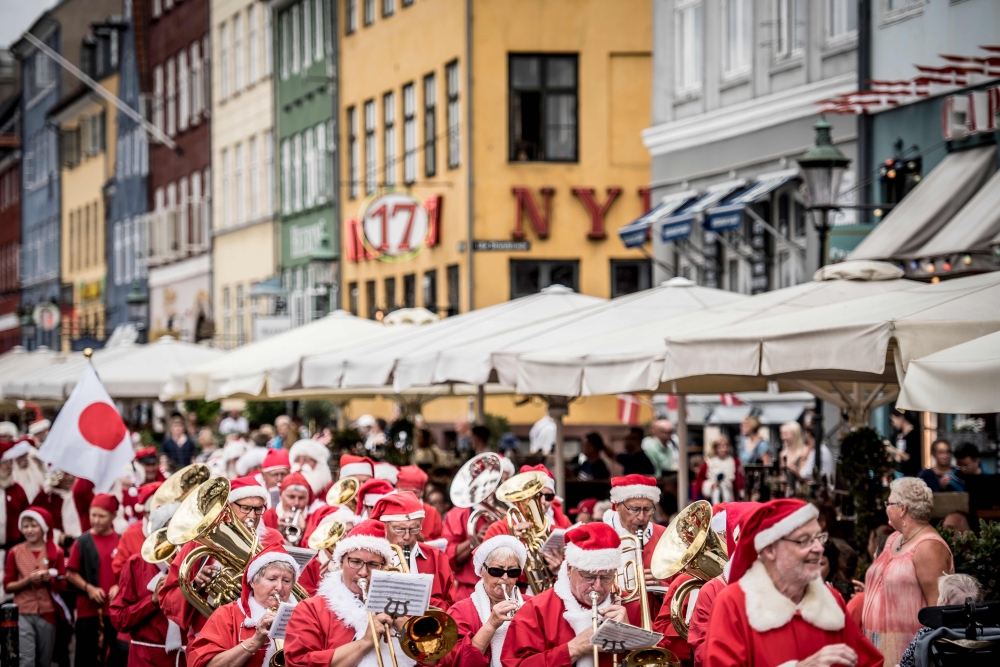 People dressed as Santa Claus and elves take part in a street parade that is part of the annual World Santa Claus Congress on Tuesday in Copenhagen, Denmark. - AFP