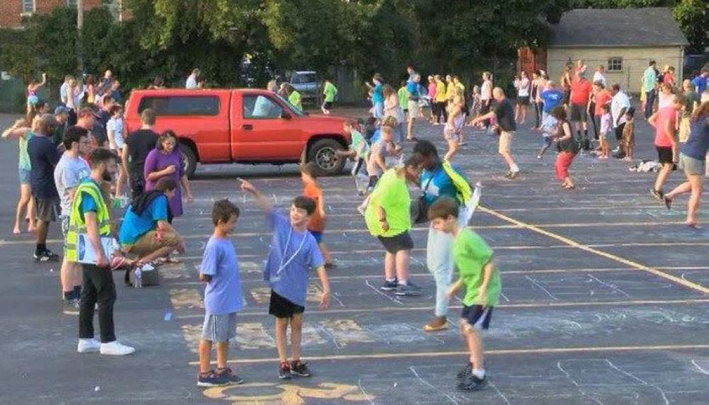 People are seen playing hopscotch during an event in Rochester, New York on Monday.