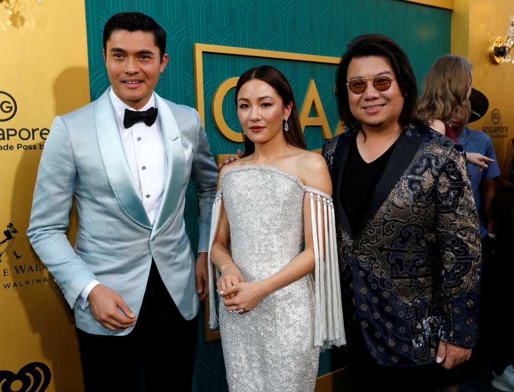 Author Kevin Kwan, right, and cast members Henry Golding and Constance Wu pose at the premiere for “Crazy Rich Asians” in Los Angeles, California, in this Aug. 7, 2018 file photo. — Reuters