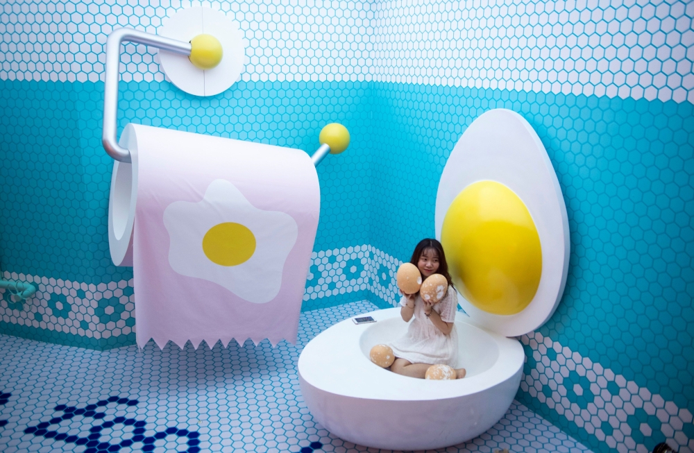 Visitors pose for photographs at The Egg House in Shanghai, China on Saturday. The Egg House is where an apparently unhealthy interest in eggs and selfies meets 
