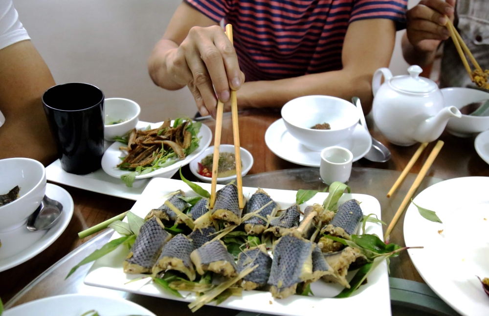 This photo taken on Aug. 24, 2018, shows diners consuming steamed snake dish at a specialty restaurant in Yen Bai province, Vietnam. - AFP