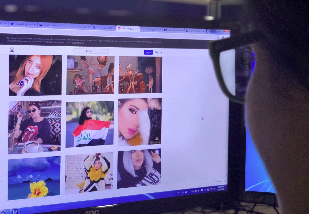 A person looks at the profile page of Iraqi model and Instagram starlet Tara Fares in Baghdad on Friday. — AFP