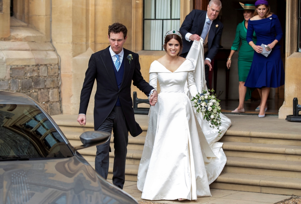 


Princess Eugenie and Jack Brooksbank leave Windsor Castle after their wedding for an evening reception at Royal Lodge, in Windsor, Britain. — Reuters