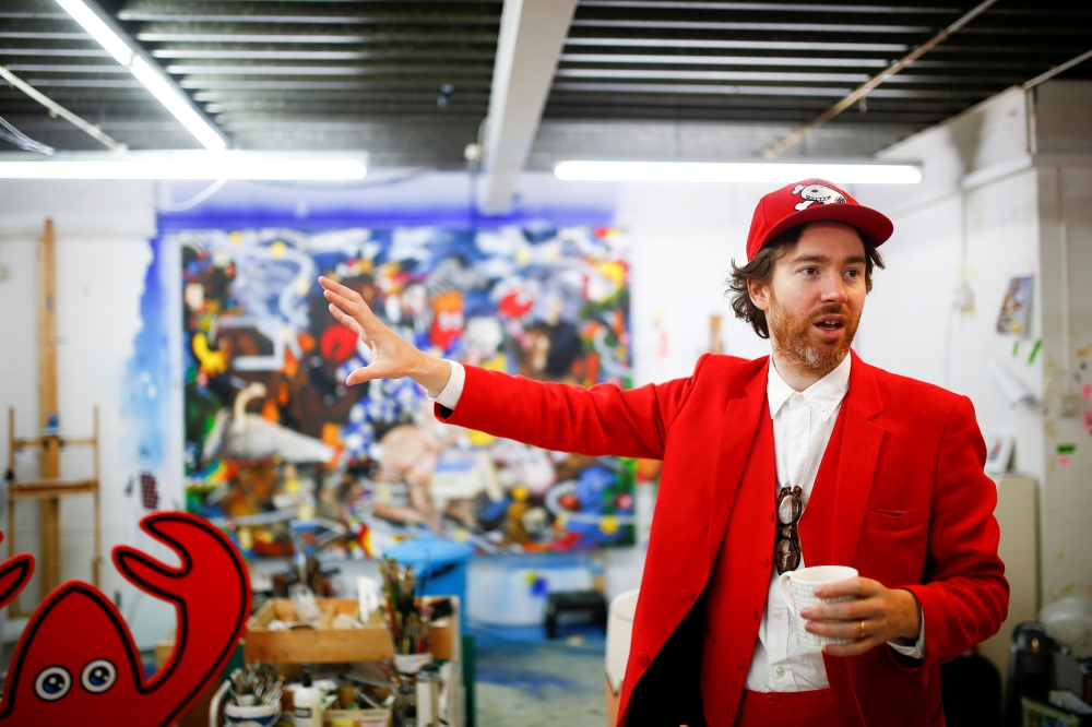 Fashion designer and artist Philip Colbert gestures at his studio in Shoreditch, London. — Reuters