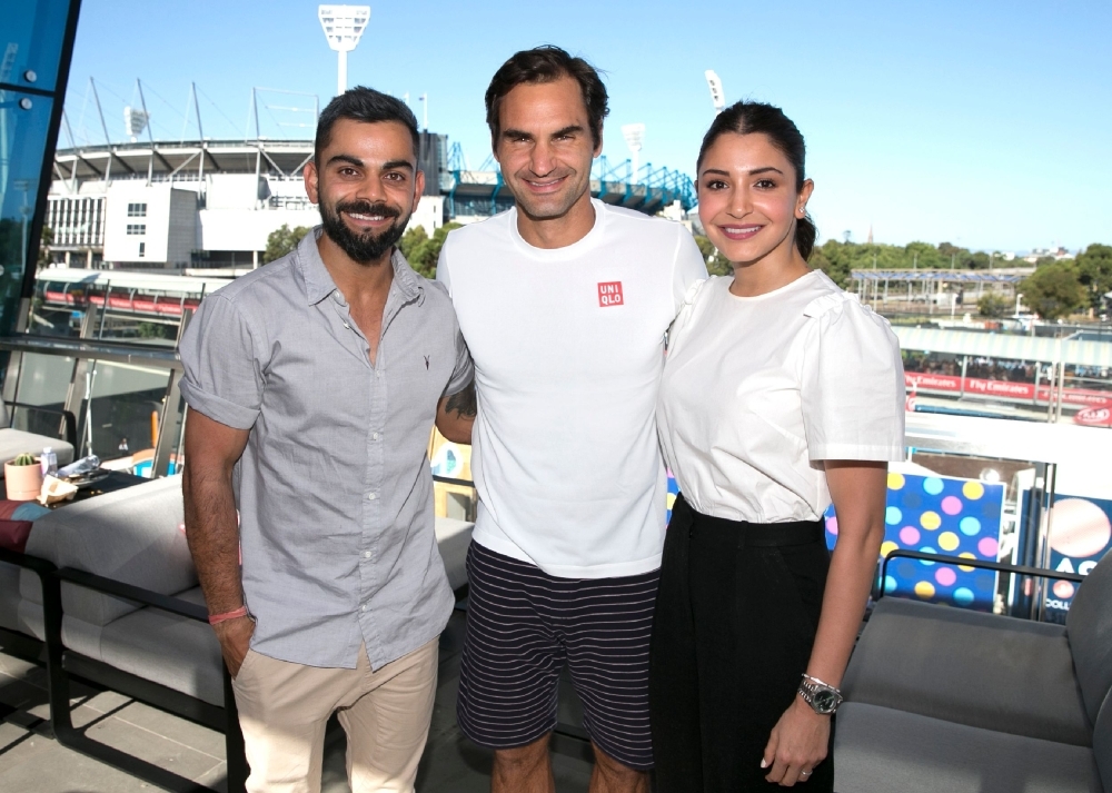 This photo shows Switzerland's Roger Federer (C) meeting Indian cricket captain Virat Kohli (L) and his wife Anushka Sharma (R) on day six of the Australian Open tennis tournament in Melbourne on Saturday. — AFP