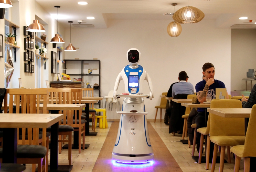 A robot waiter serves customers at a cafe in Budapest, Hungary. — Reuters