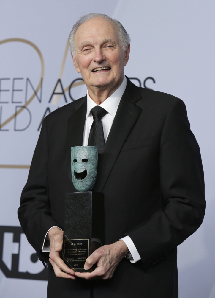 Alan Alda poses backstage with his Life Achievement Award. — Reuters