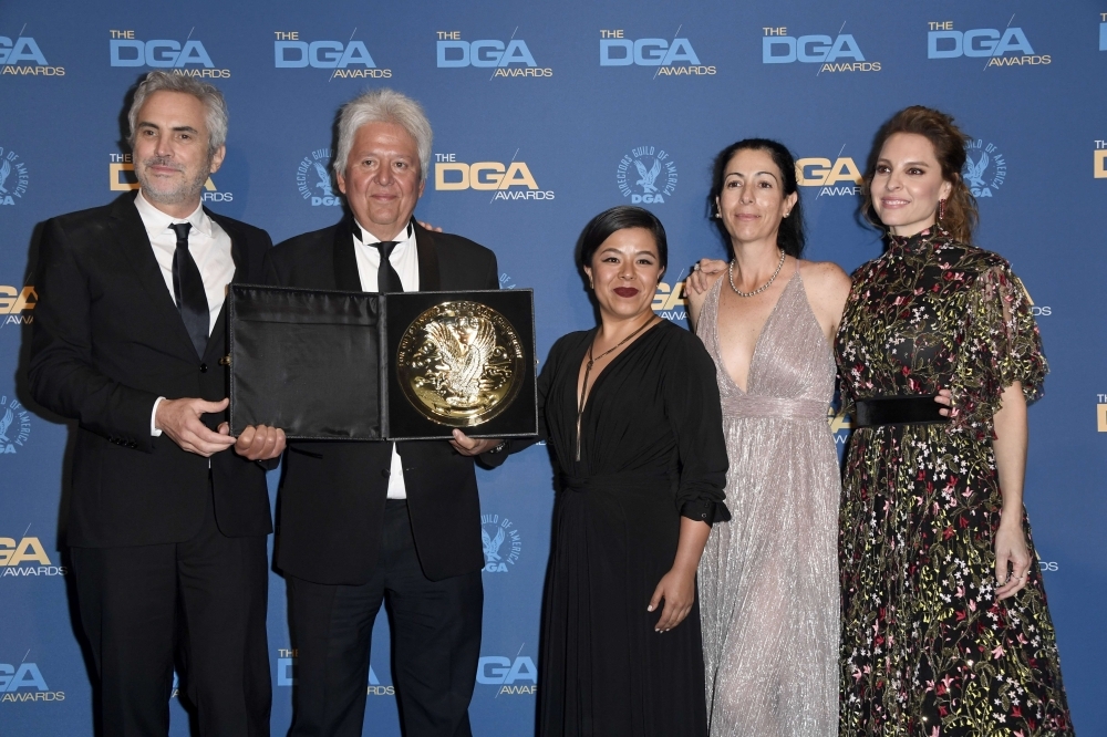 DGA Feature Film Award winner for 'Roma' Alfonso Cuaron (L) poses in the press room during the 71st Annual Directors Guild Of America Awards at The Ray Dolby Ballroom at Hollywood & Highland Center in Hollywood, California. — AFP