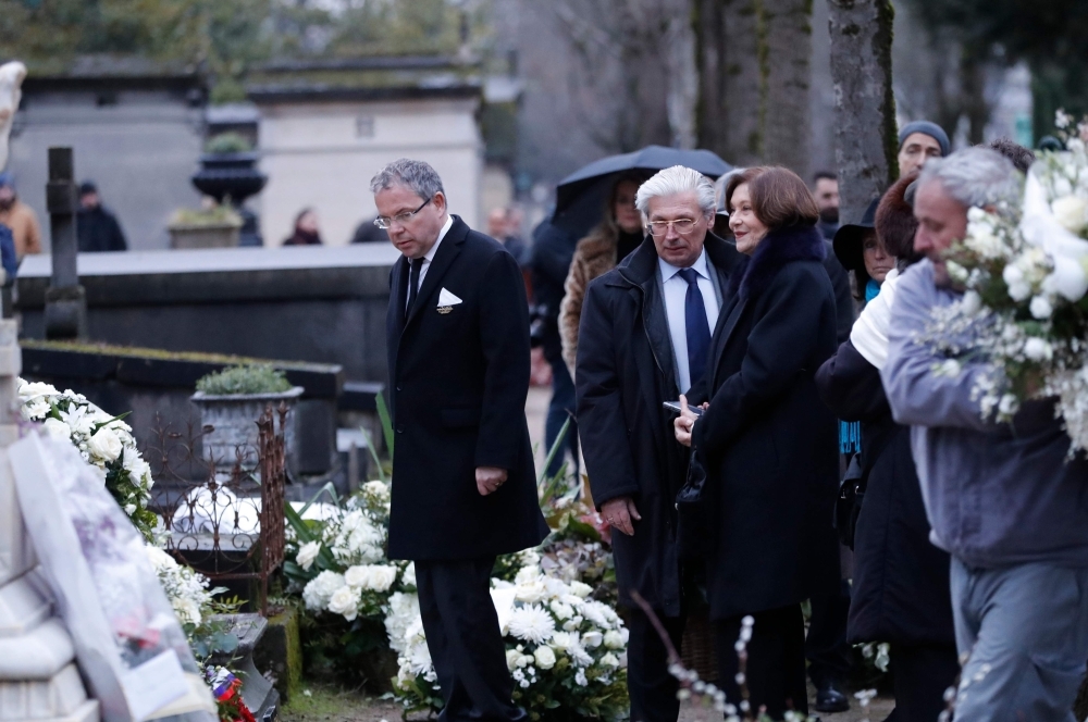 French actress Macha Meril (R) in front of the grave of her late husband French music composer Michel Legrand during his burial at the Pere Lachaise cemetery in Paris. — AFP