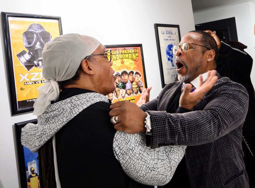 In this photo taken on Jan. 19, 2019 Melvin Glover, aka Melle Mel hugs Guy O'Brien, aka Master Gee from the Sugarhill gang at the Hip-Hop Museum Pop Up Experience in Washington, DC.  — AFP
