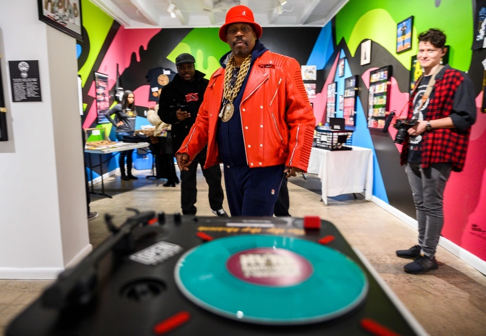 In this photo taken on Jan. 19, 2019 Melvin Glover, aka Melle Mel hugs Guy O'Brien, aka Master Gee from the Sugarhill gang at the Hip-Hop Museum Pop Up Experience in Washington, DC.  — AFP