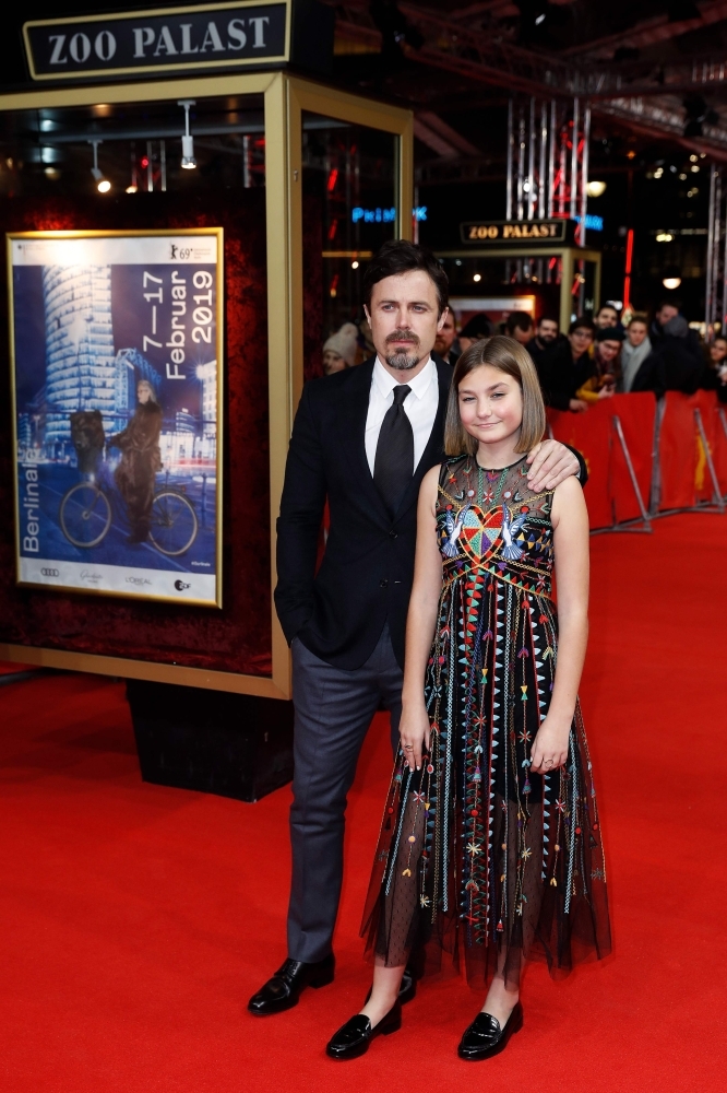 US actor and director Casey Affleck and actress Anna Pniowsky walk over the red carpet as they arrive for the premiere of the film 