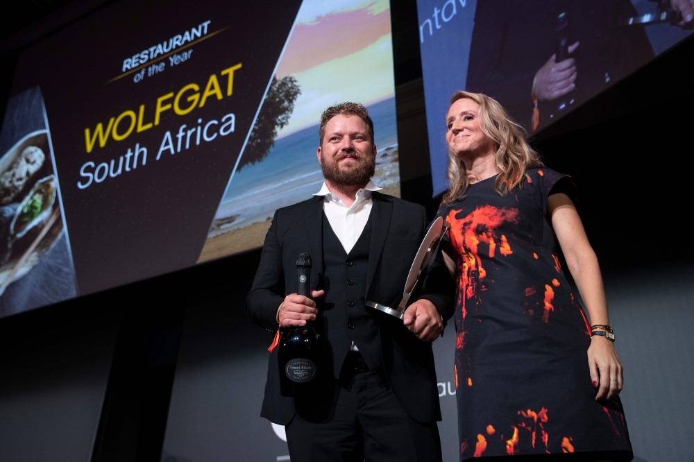 Chef Kobus van der Merwe (L) receives the best Restaurant of the year award for his restaurant 
