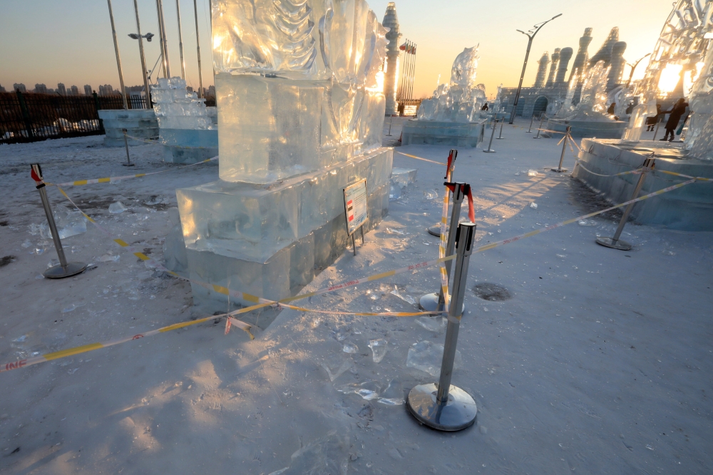Security lines are seen set up for protecting visitors from falling ice from melting ice sculptures at the venue of the Harbin International Ice and Snow Sculpture Festival on its closing day, in Heilongjiang province, China. — Reuters