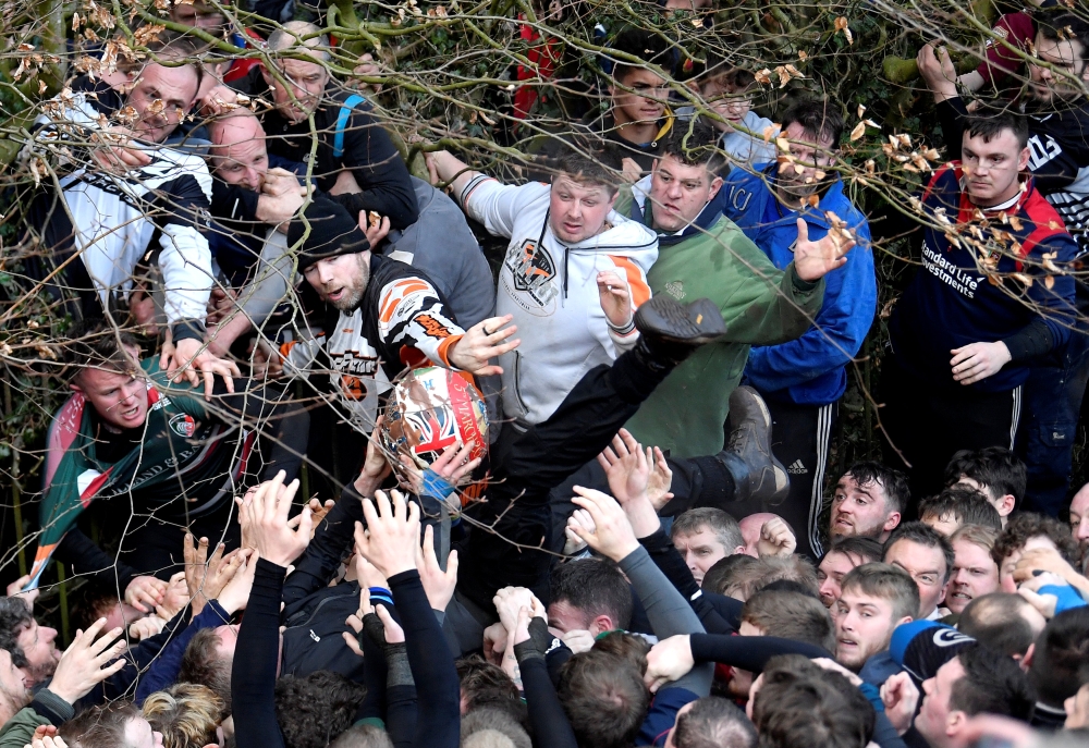 Players fight for the ball during the annual Shrovetide football match in Ashbourne, Britain. — Reuters