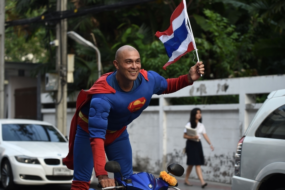 


Thai-German national David Pfizenmaier performs a bike stunt whilst encouraging Thais to vote in the upcoming election in Bangkok. – AFP