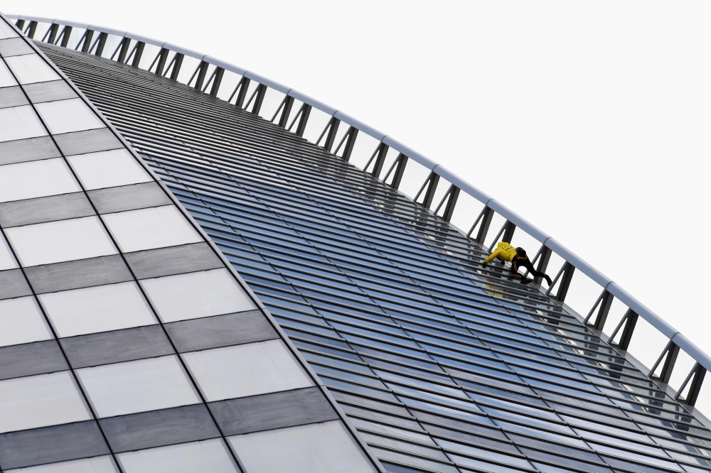 


Alain Robert, the French urban climber dubbed Spiderman, climbs French Energy group Engie's building in the La Defense business district outside Paris. — AFP