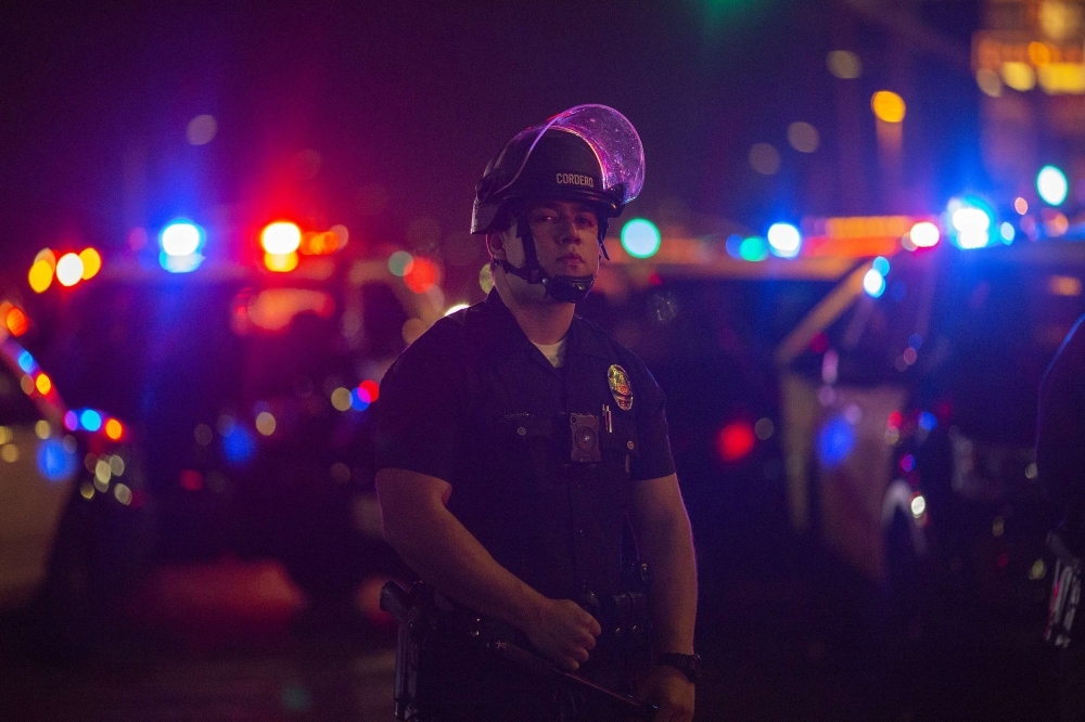 Police force people to leave after a stampede broke out at a gathering of hundreds of people mourning the murder of Nipsey Hussle in Los Angeles, California. — AFP