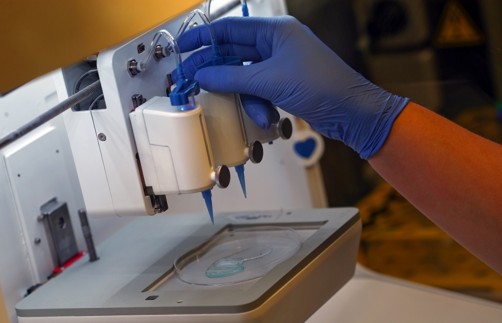 An employee checks the 3D printing of a scaffold for a kidney at Dr. Ali Ertuerk’s laboratory in Munich, Germany, on Tuesday. — Reuters