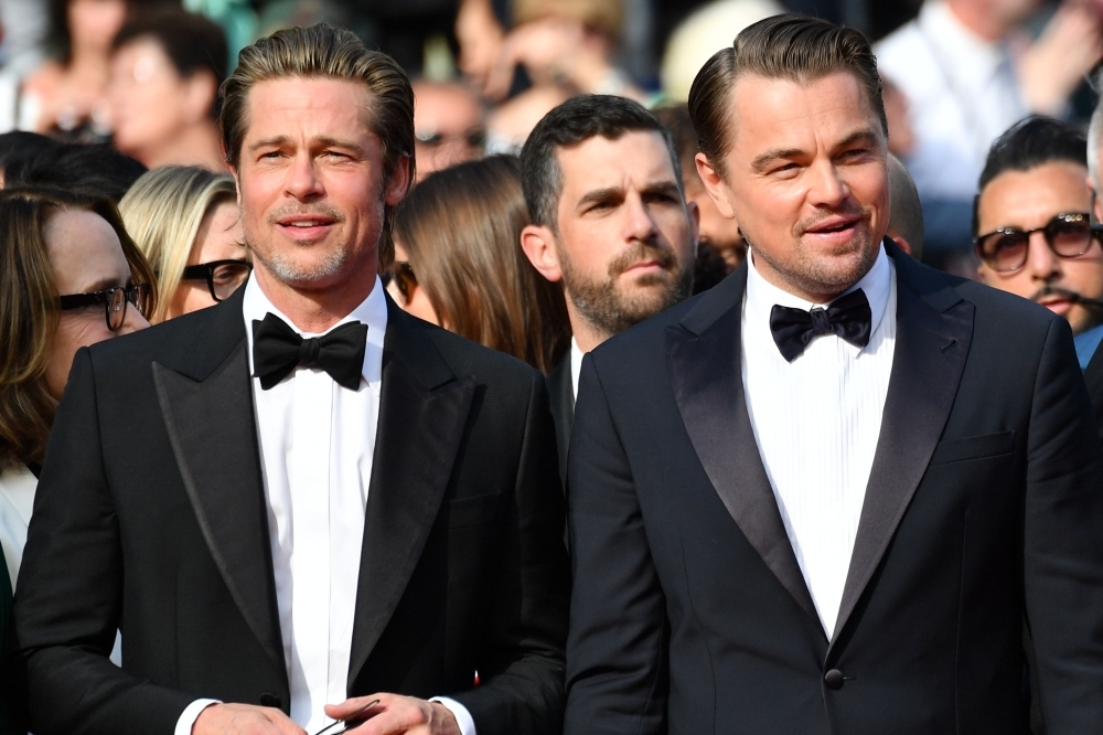 US actor Brad Pitt and US actor Leonardo DiCaprio arrive for the screening of the film 