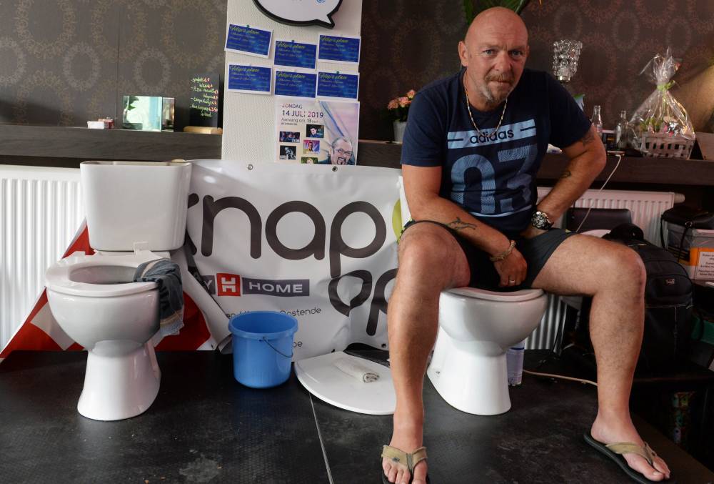Belgian Jimmy de Frenne sits on a toilet in a cafe in an attempt to enter the Guinness Book of Records for a new record for sitting on a toilet for the longest time, in Ostend, Belgium, Friday. — Reuters